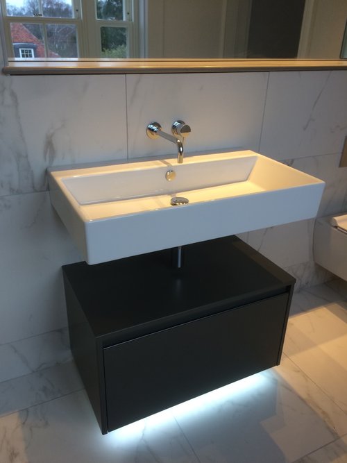 A lovely modern sink that is large and square, modern tap with under sink cupboard.